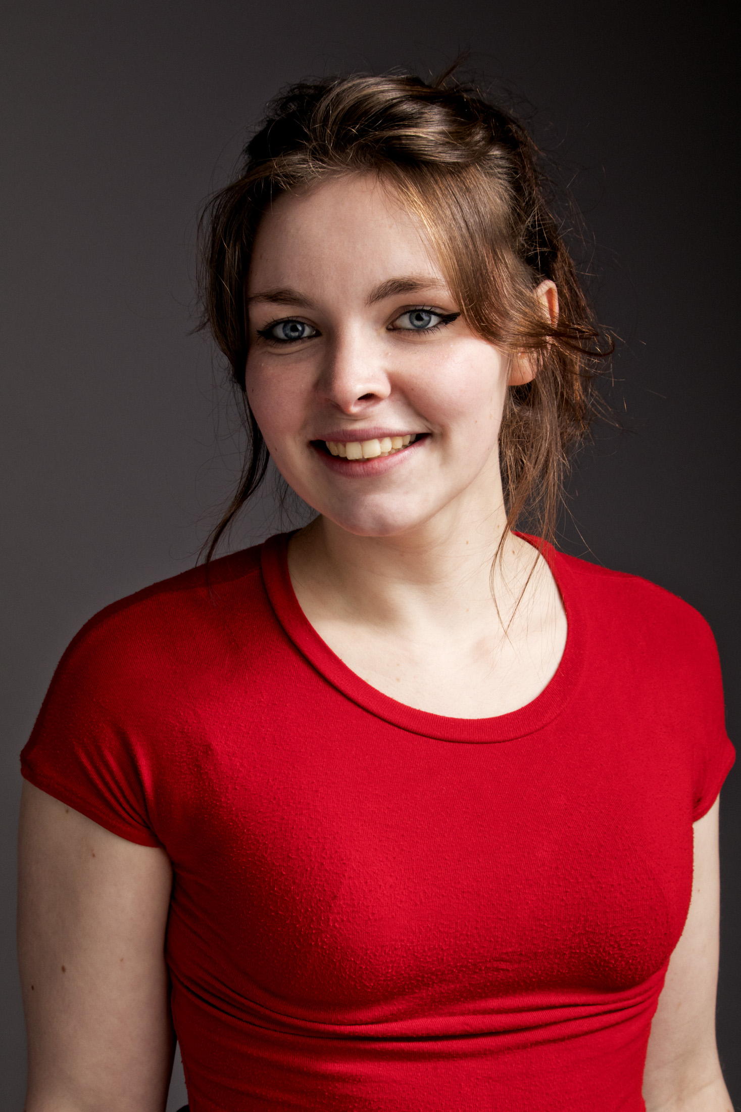 Kate Boleyn in a red top smiling to camera